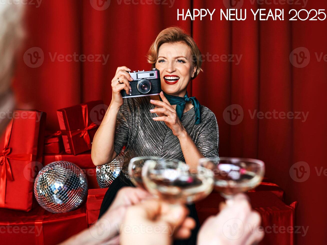 Cheerful beautiful photographer woman at the party celebration on red curtains background. Profession, party concept photo