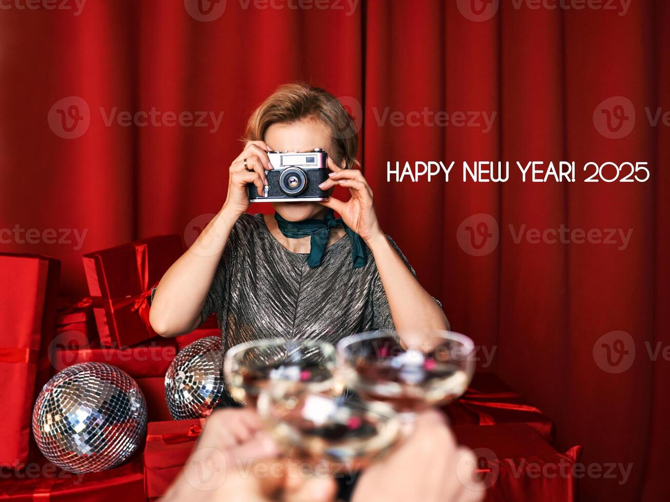 Cheerful beautiful photographer woman at the party celebration on red curtains background. Profession, party concept photo