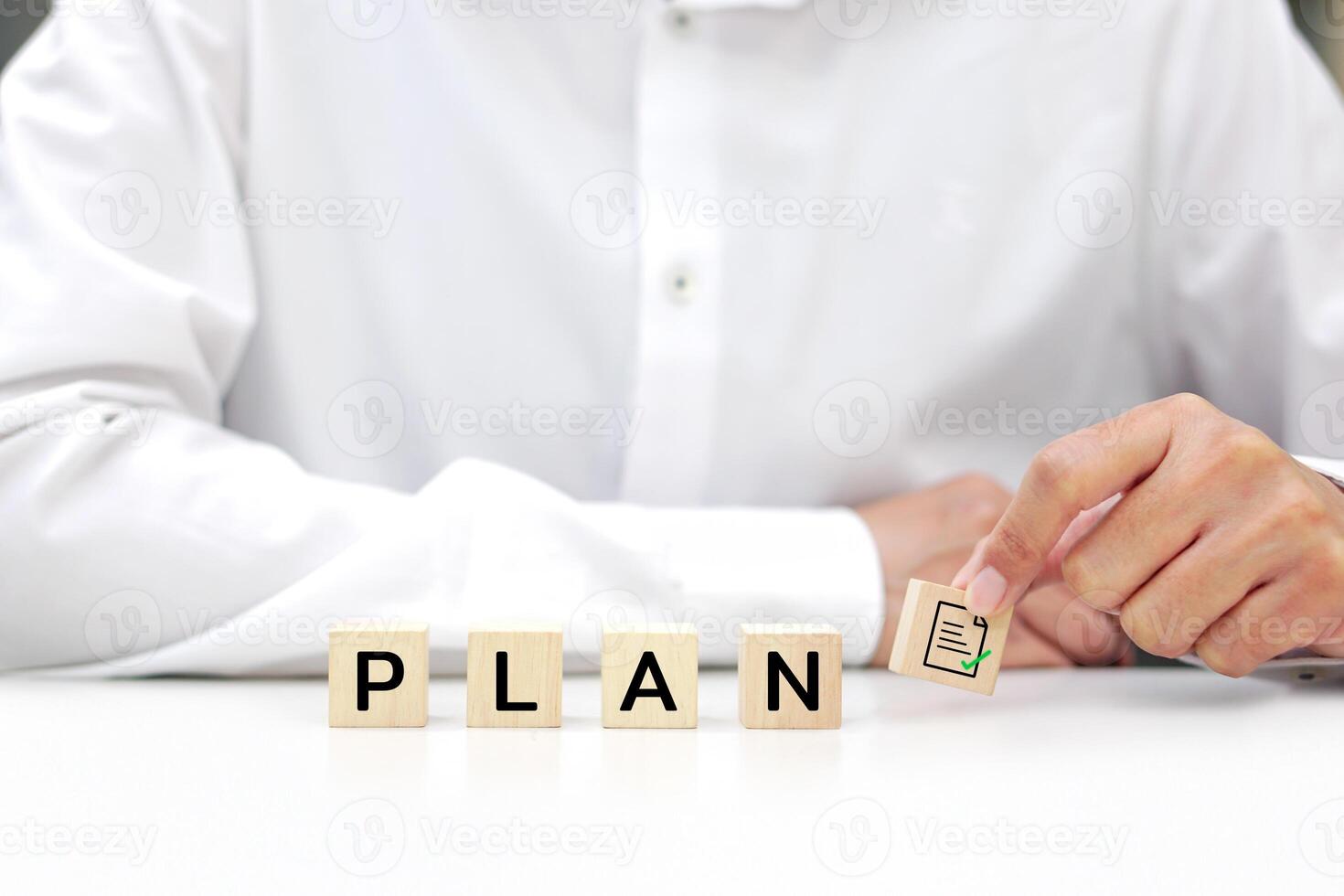 Businessman holding wooden block with text. Planning, analysis, work in cooperation and business process concept. photo