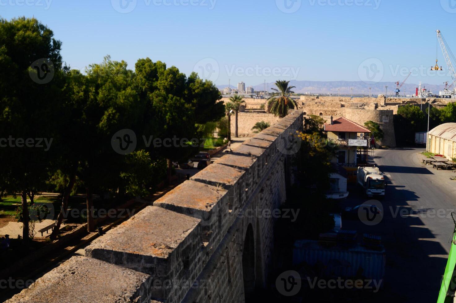 Exploring ancient walls and lush greenery in a historic part of the city on a sunny day photo