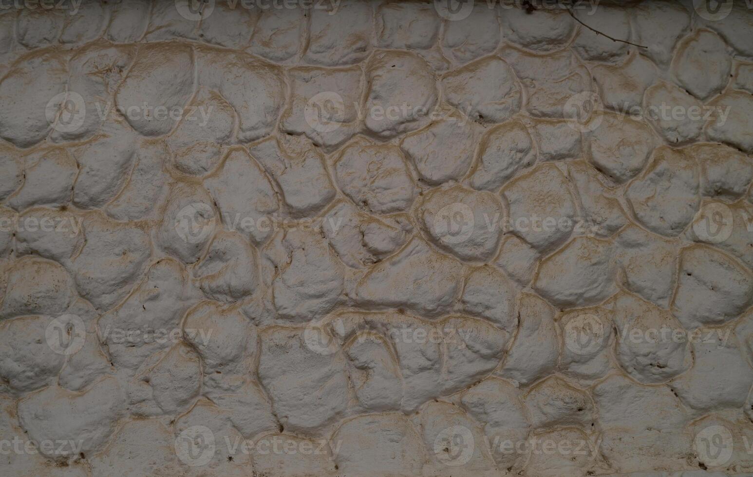 Textured white wall resembling natural stone, highlighting craftsmanship and design in an indoor space photo