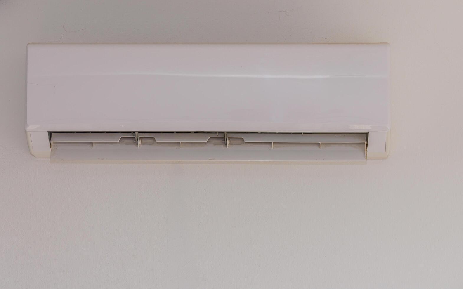 A Sleek White Air Conditioning Unit Mounted on a Wall Providing Cool Comfort During the Warm Summer Months in a Modern Living Space photo