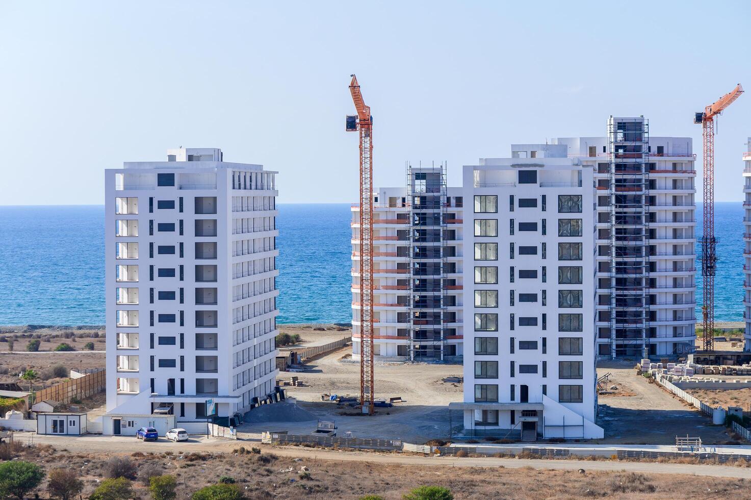 Coastal Construction in Progress at a Modern Development Overlooking the Serene Blue Waters of the Ocean on a Sunny Day photo