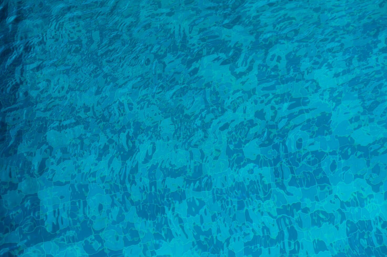 The Serene Beauty of Crystal-Clear Water Glistening Under the Sun in a Tranquil Swimming Pool Oasis During a Hot Summer Day photo