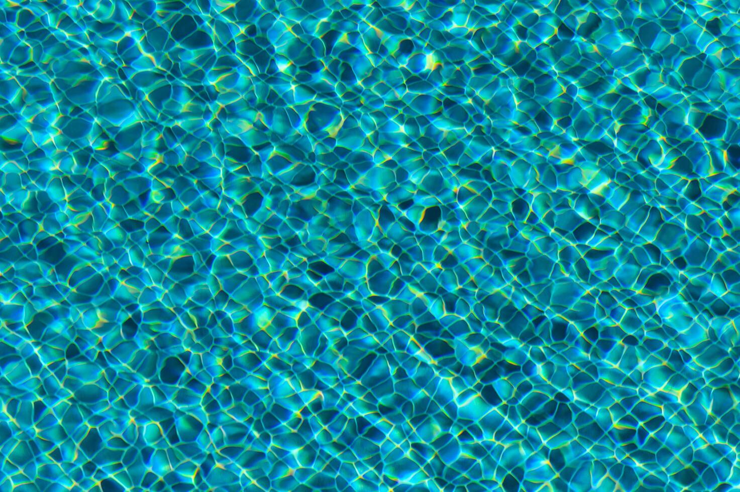 Reflective Ripples Dance Across Vibrant Turquoise Water in a Sunlit Pool, Inviting Serenity and Relaxation on a Warm Summer Day photo