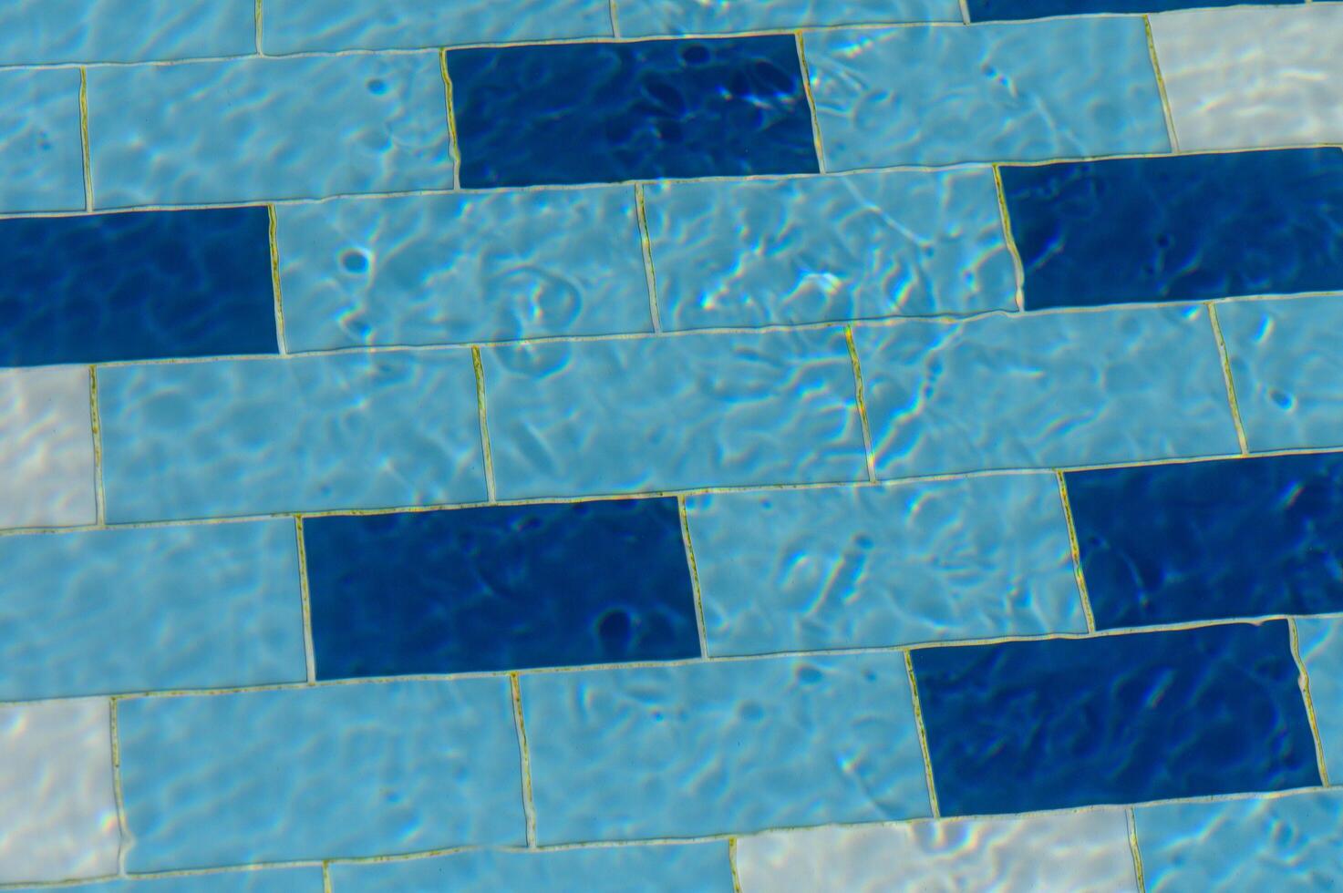 Underwater Mosaic Tiles Glisten in the Sun at a Vibrant Pool, Inviting Relaxation on a Warm Summer Day photo