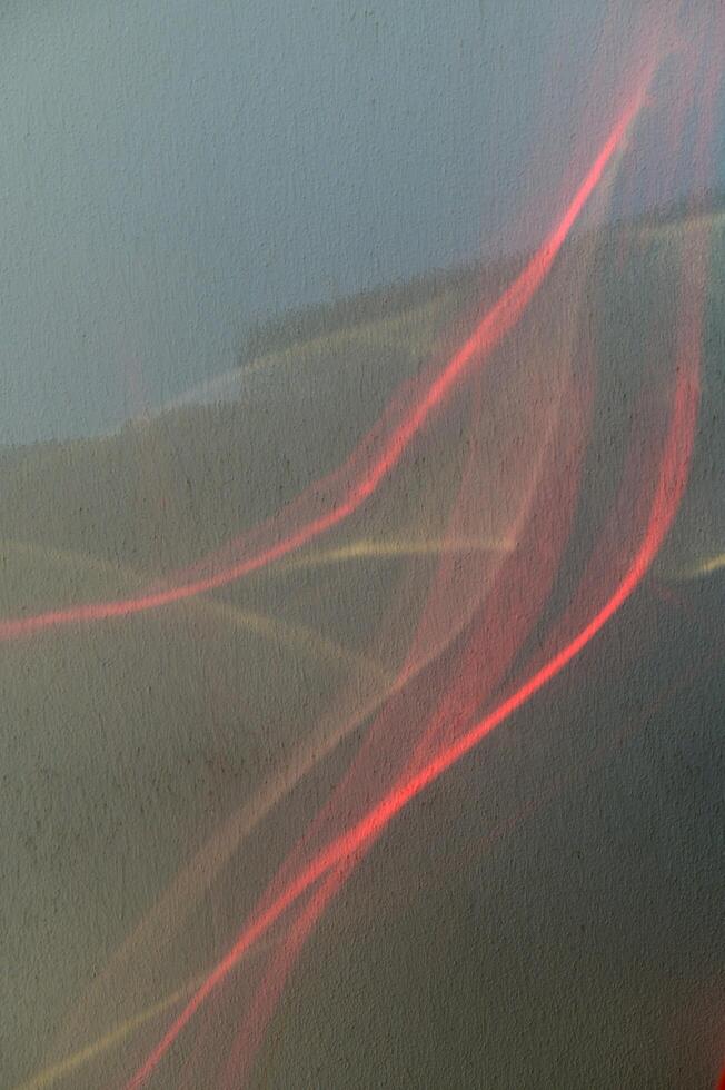 Abstract Light Trails Dance Across the Canvas of a Twilight Sky, Blending Hues of Red With the Contemplative Shadows of Dusk photo