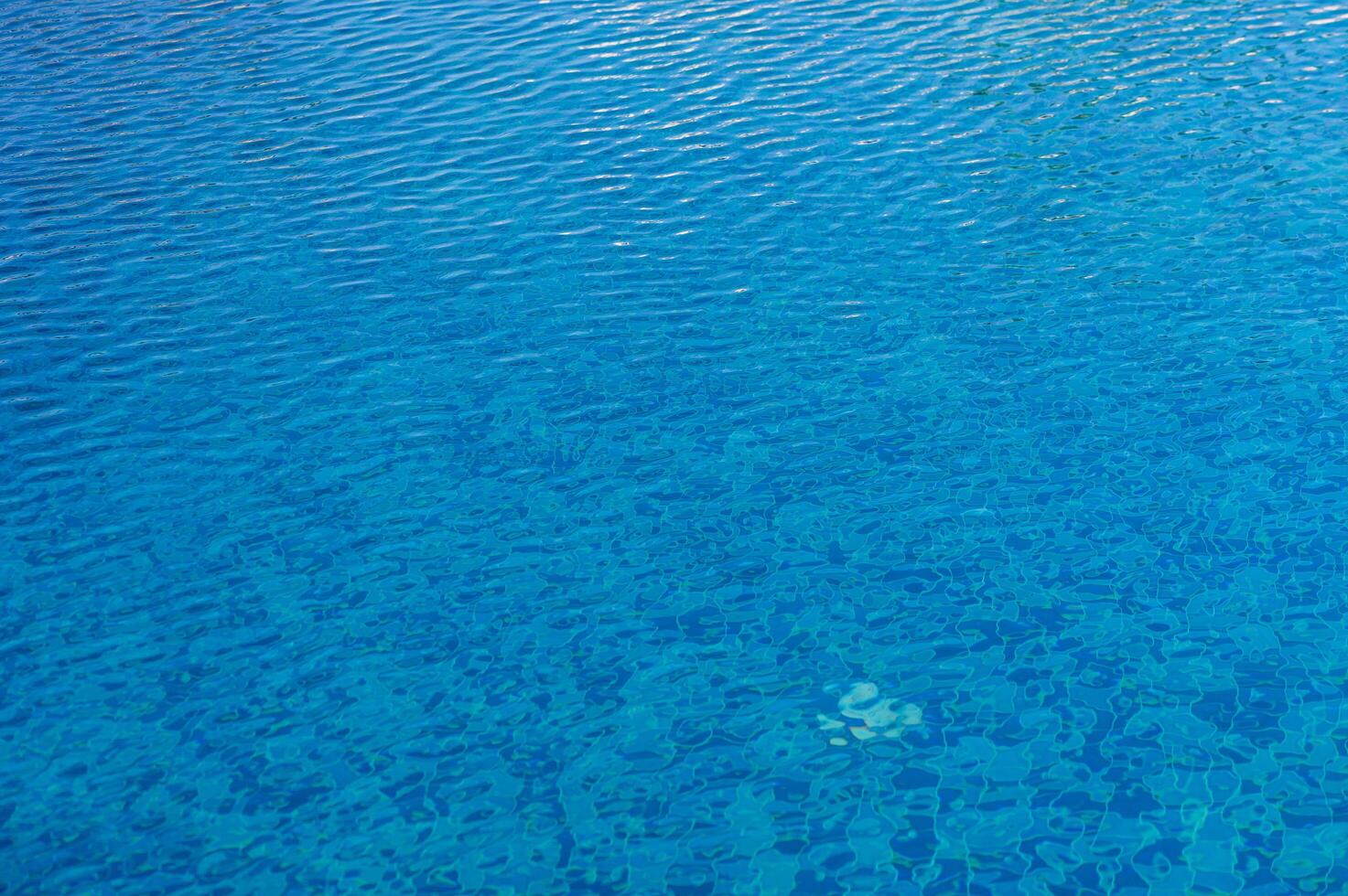 Luminous Turquoise Waters Inviting Refreshment Under the Radiant Summer Sun in a Tranquil Resort Setting photo