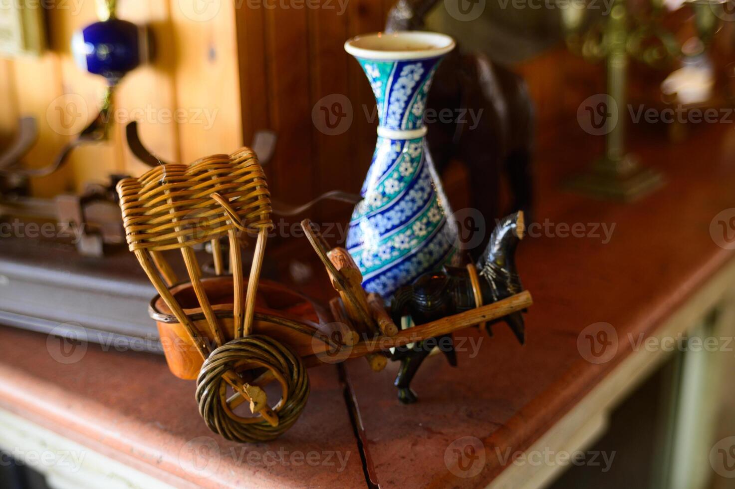 A handcrafted cart carrying a vibrant vase, showcasing artisanal craftsmanship in a cozy shop setting photo