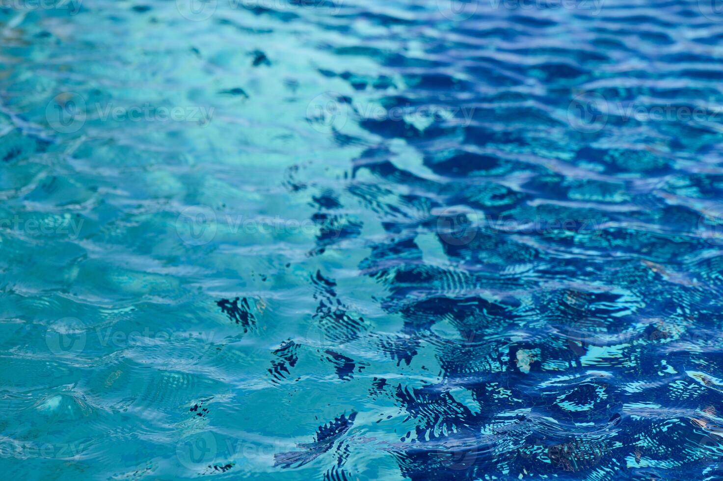 Captivating reflections on tranquil blue water as sunlight dances on the surface photo