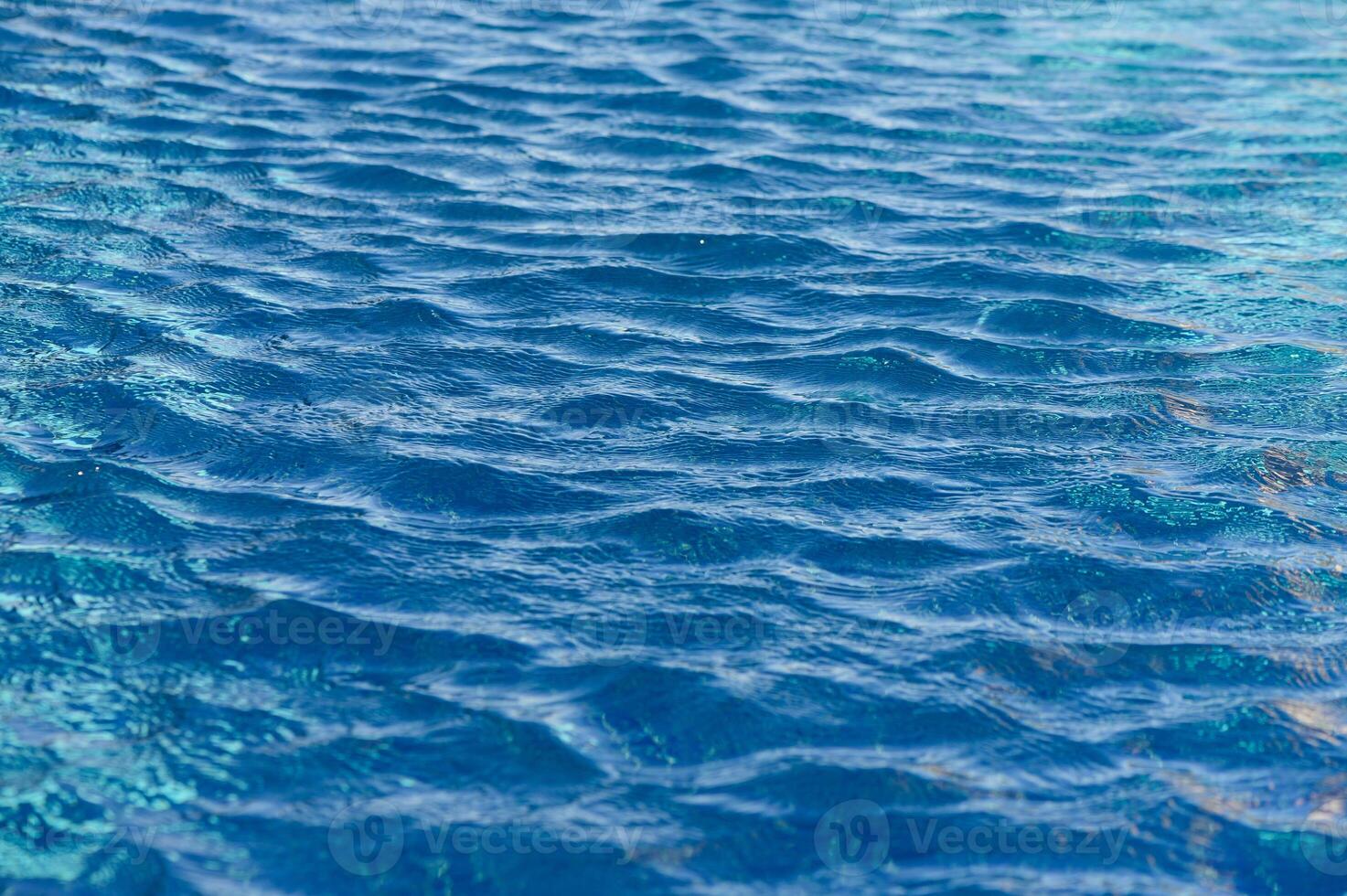 Rippling azure waves create a serene atmosphere on a sunny day at the tranquil poolside retreat photo