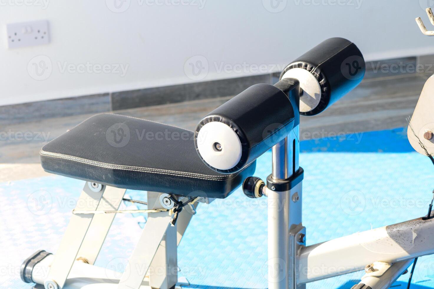 A Versatile Weight Training Bench Set Against a Bright, Modern Gym Backdrop Emphasizing Fitness and Strength Training Techniques photo