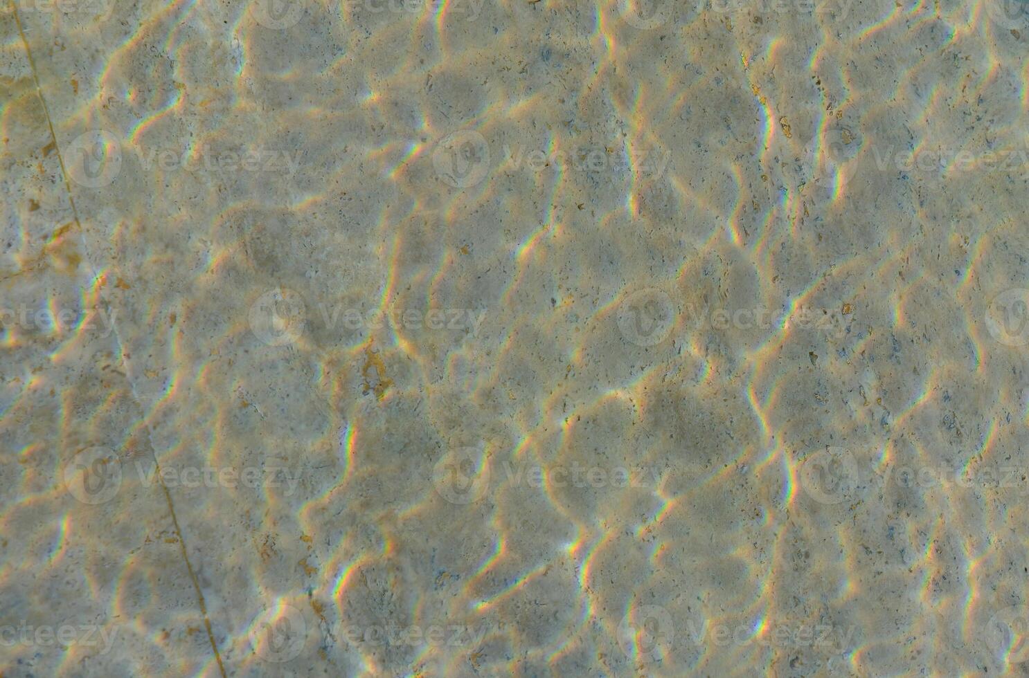Captivating Ripples of Sunlight Dancing on a Crystal-Clear Pool Surface During a Tranquil Summer Afternoon photo