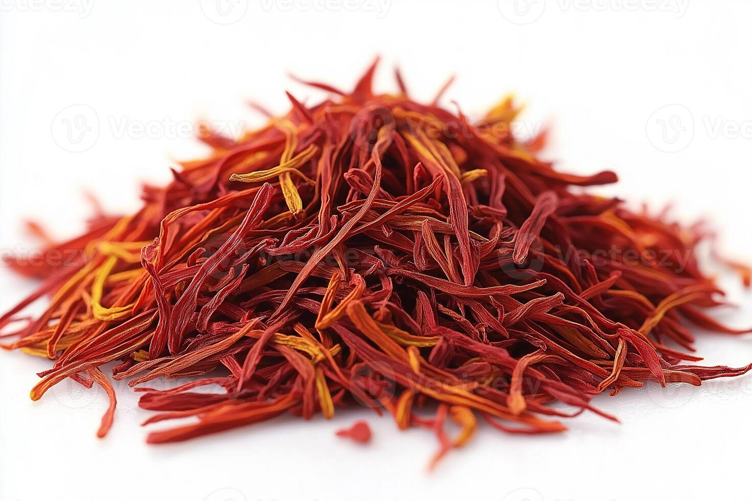 A vibrant heap of saffron threads showcasing their rich color against a bright background. photo