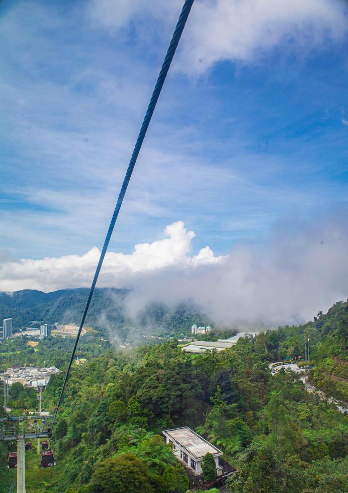 The stunning view from a cable car with a foggy in over the mountains, Rainforest, Malaysia. Bird's eye view. Aerial view. photo