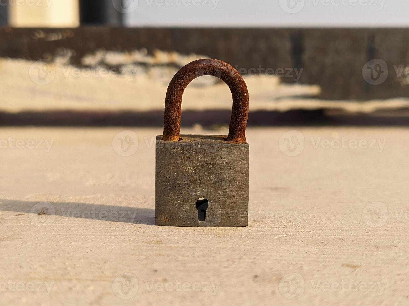 A padlock on a concrete floor photo