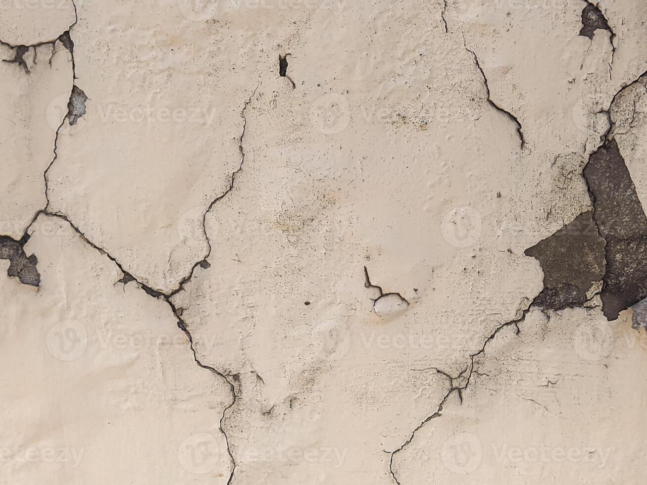 A close up of a cracked wall with peeling paint photo