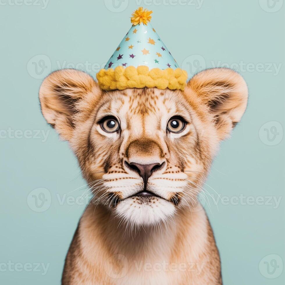 A playful lion cub wearing a festive party hat against a pastel background, embodying joy and celebration. photo