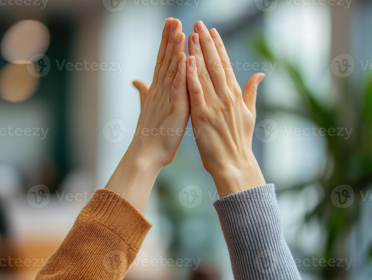 Two hands meeting in a gesture of connection, symbolizing unity and collaboration in a bright and modern environment. photo