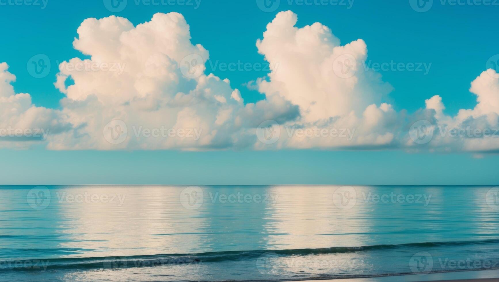 A beach with a large body of water and some clouds photo