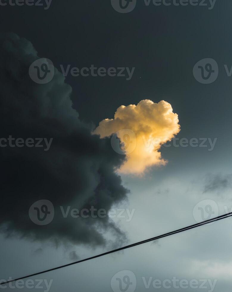 A cloud is seen in the sky above a power line photo