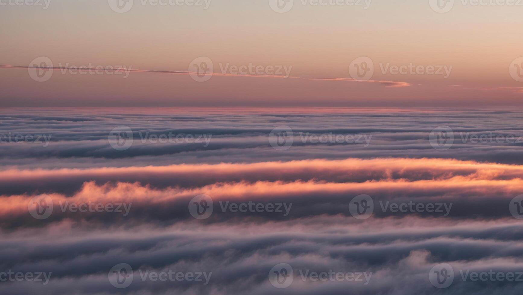 A view of the clouds from an airplane at sunset photo