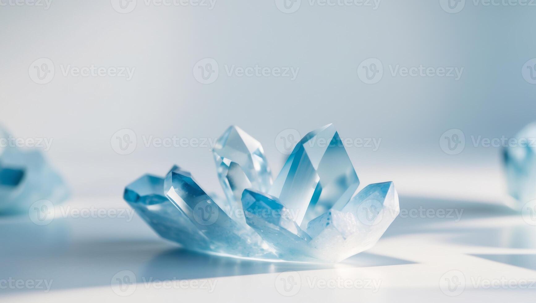 Three blue crystals sitting on a white surface photo