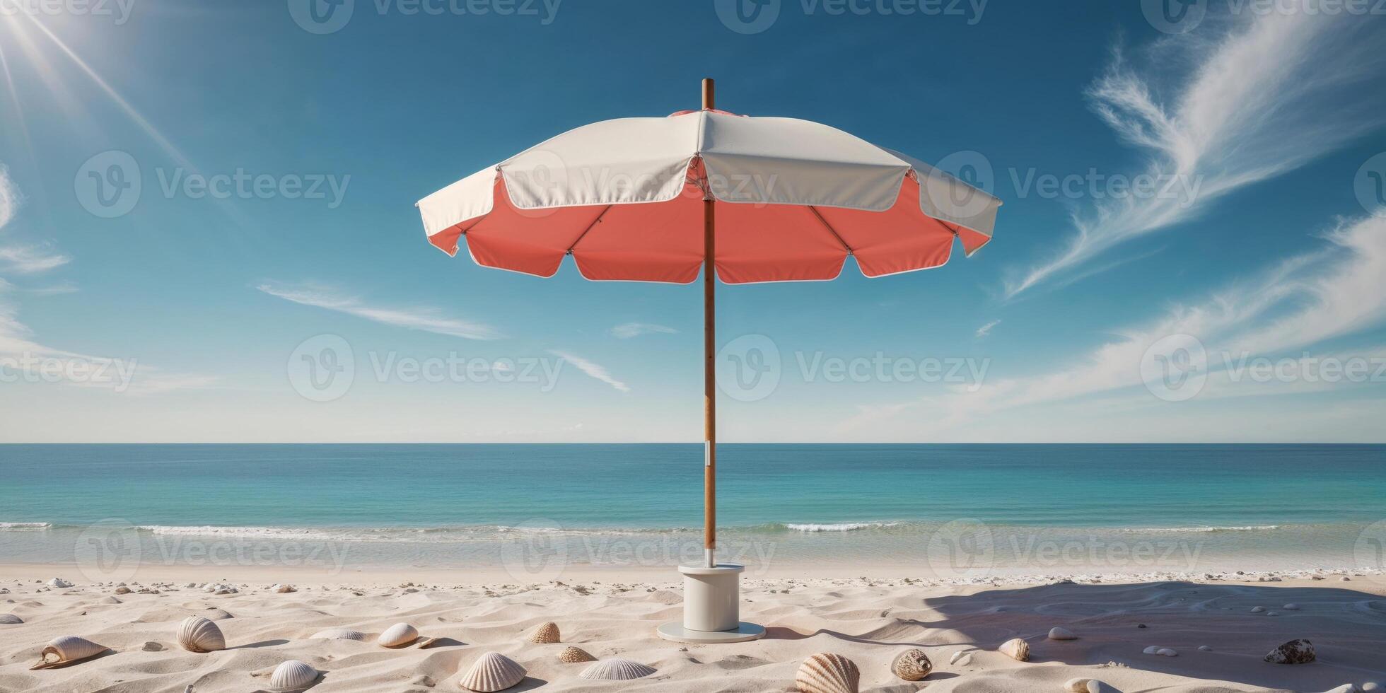 An umbrella on the beach with shells and sand photo