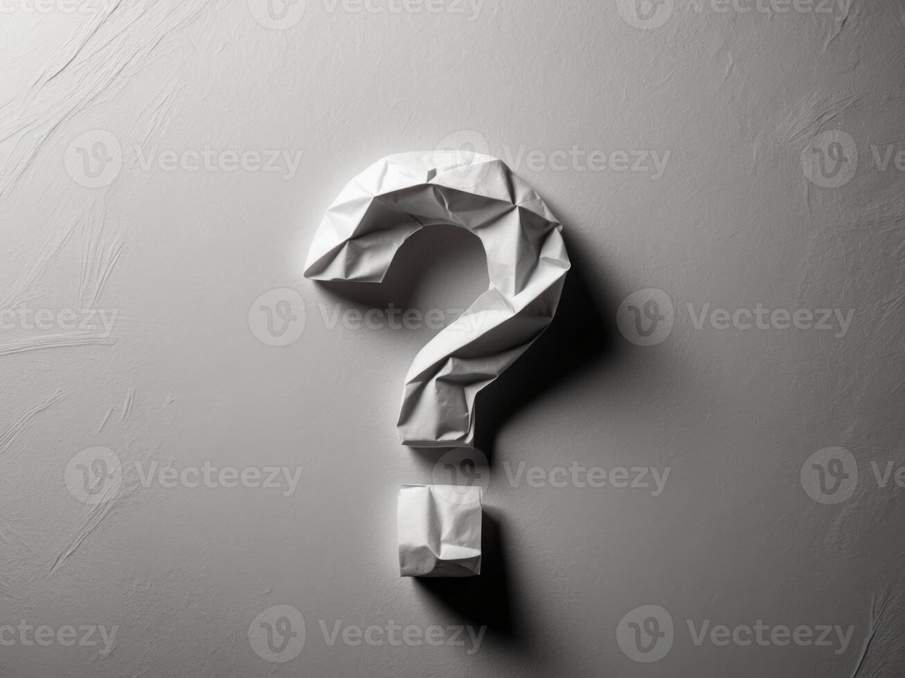 Question mark origami paper on grey background photo