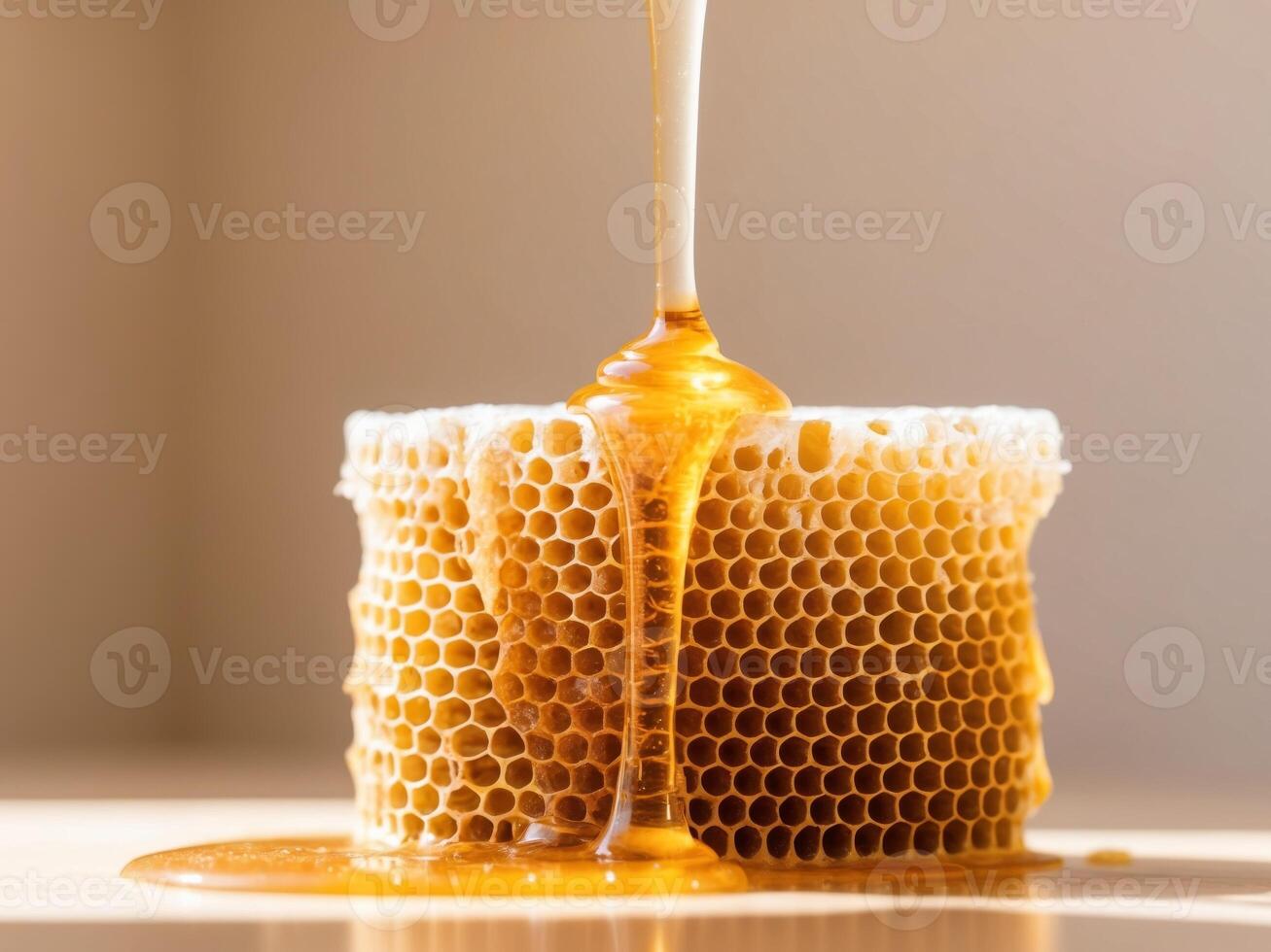 Honey dripping from a honeycomb photo