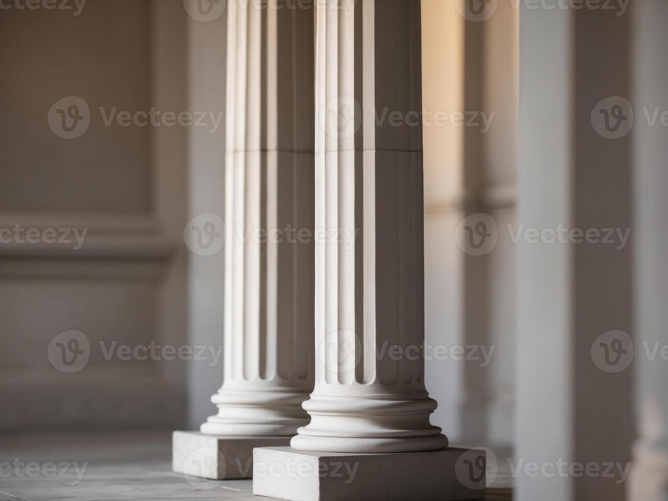 Three columns in a room with white walls photo