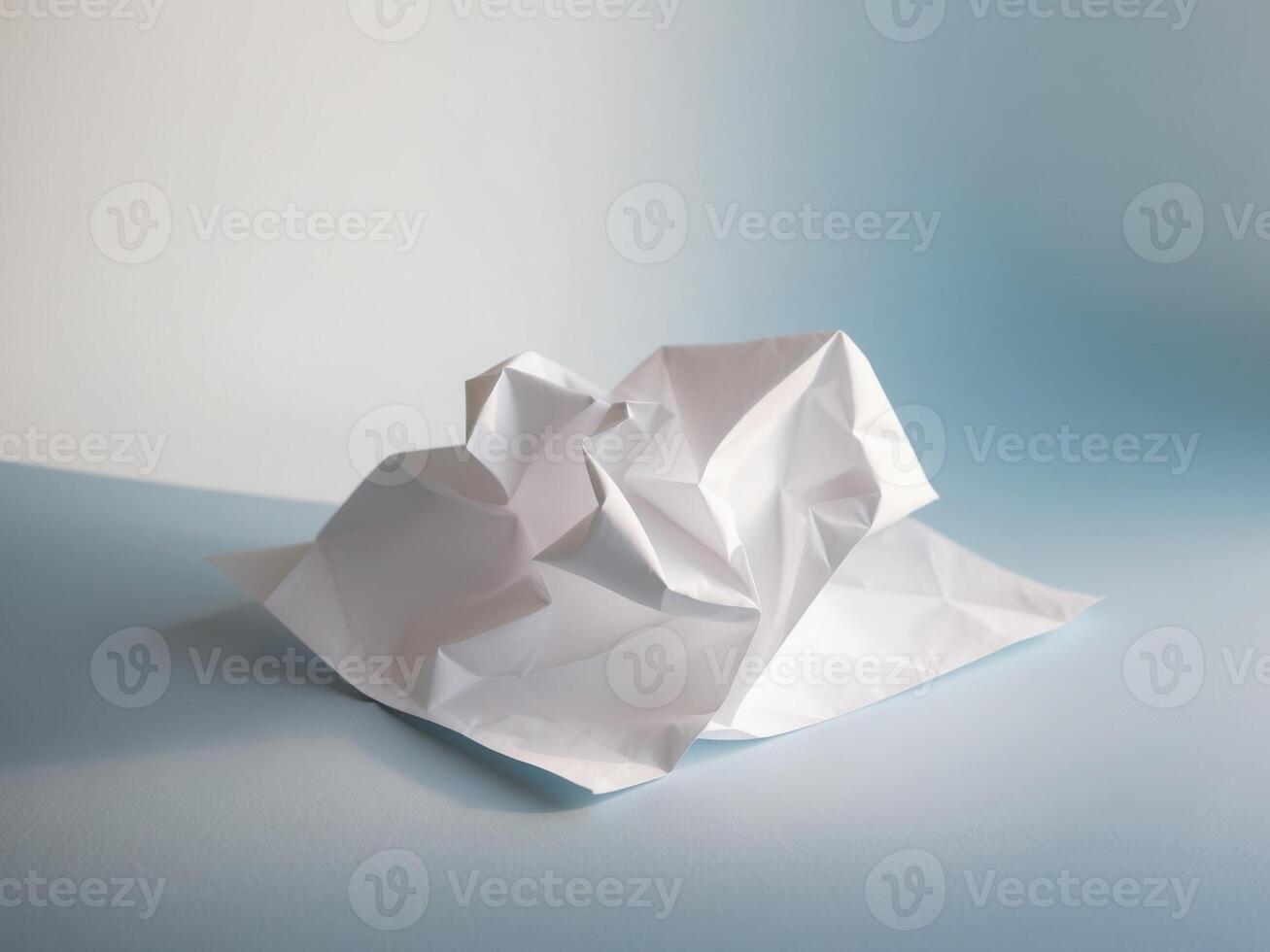 A folded piece of paper on a blue surface photo