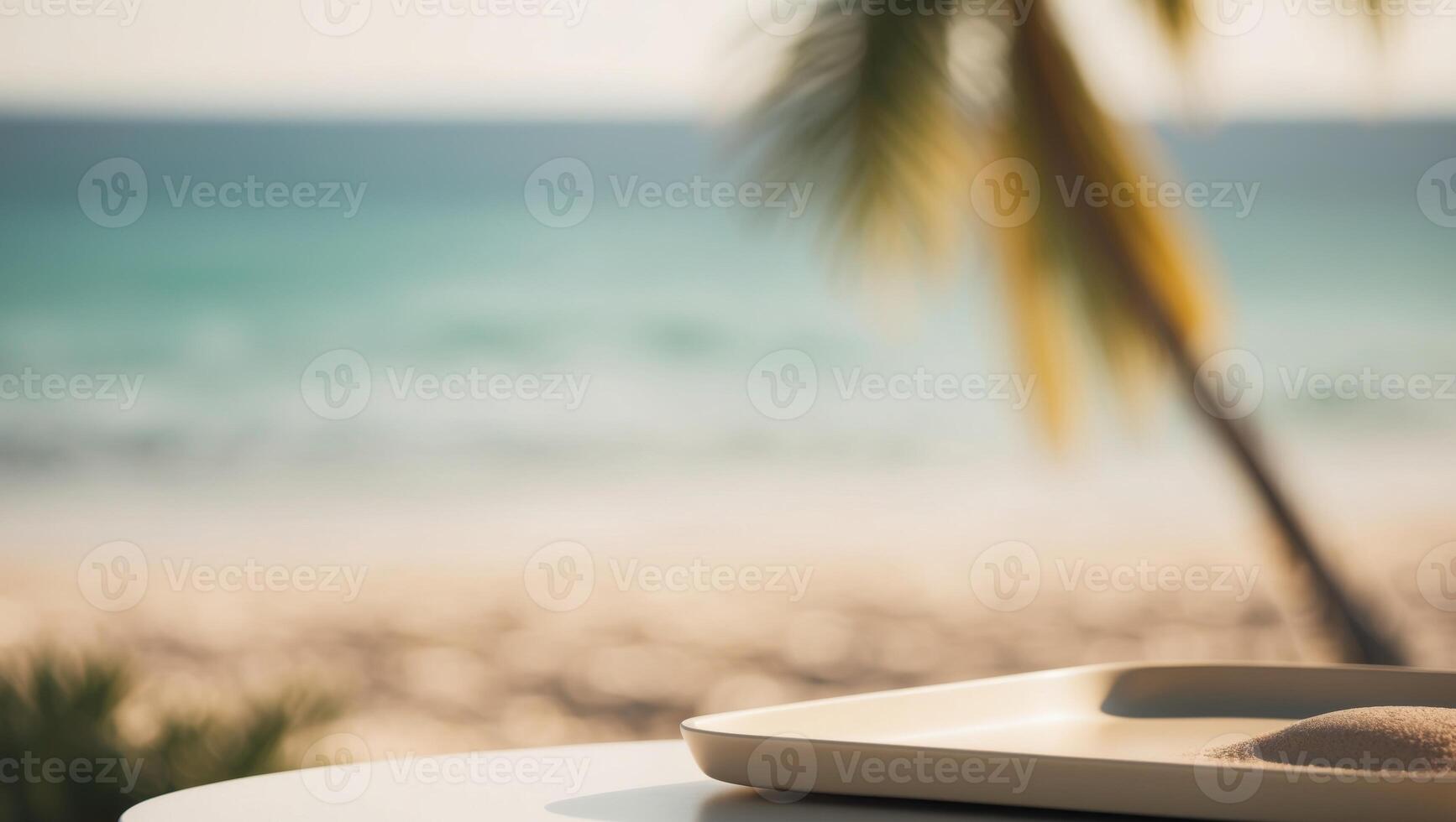A white plate with sand on the table in front of a beach photo