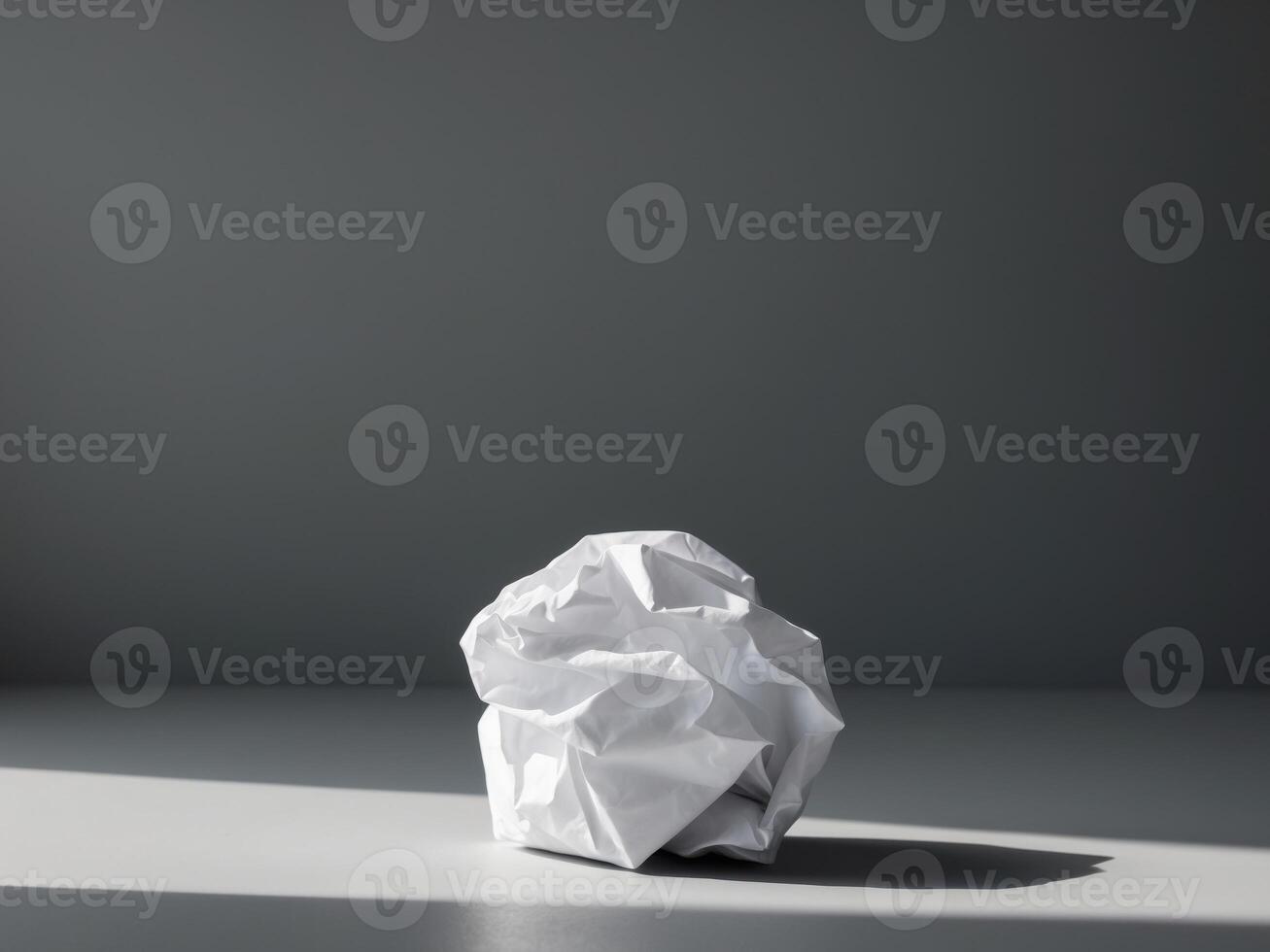 A crumpled ball of paper sitting on a table photo
