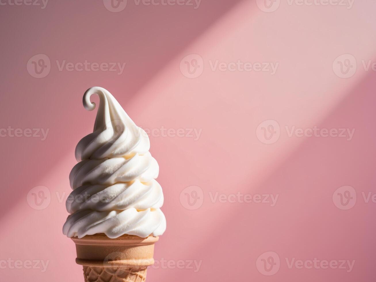 An ice cream cone with white frosting on a pink background photo