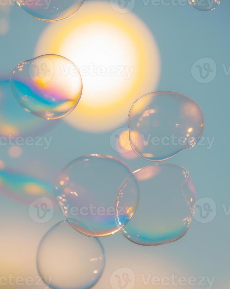 Soap bubbles floating in the air with the sun in the background photo