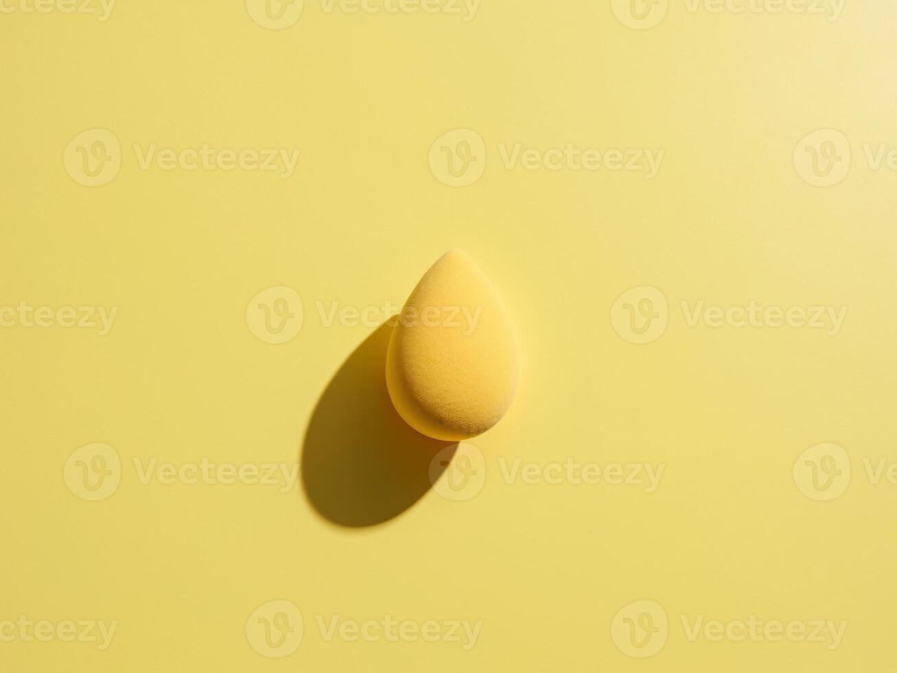 A yellow sponge on a yellow background photo