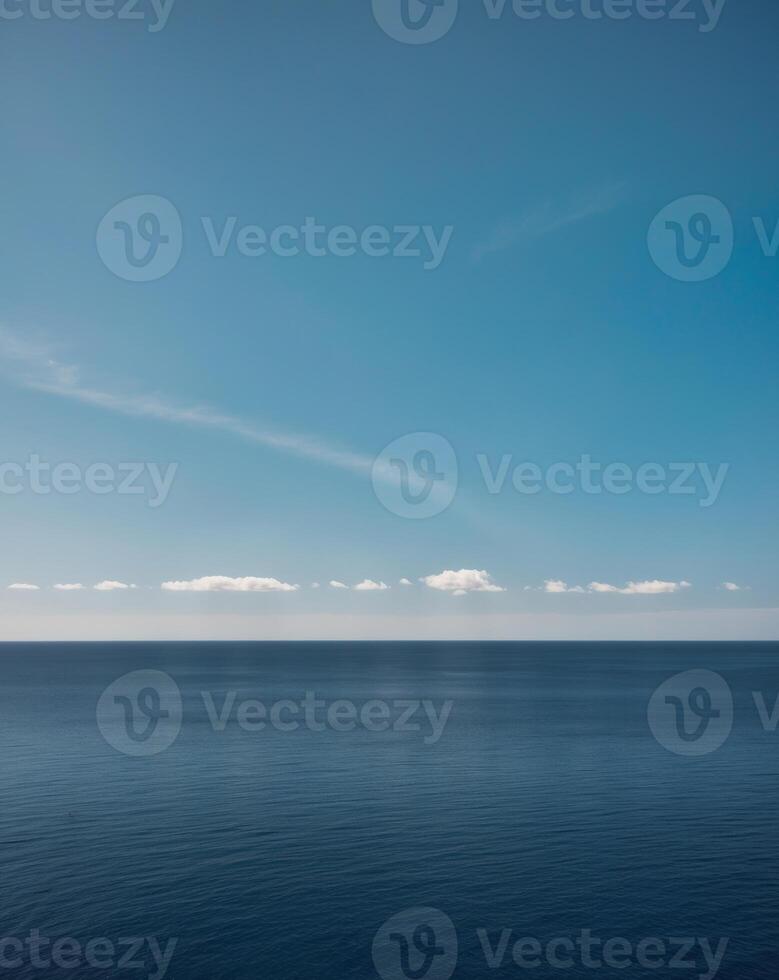 A blue sky and a white cloud over the ocean photo