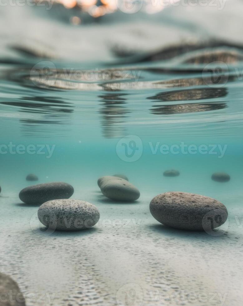 A group of rocks and water are shown under the surface photo