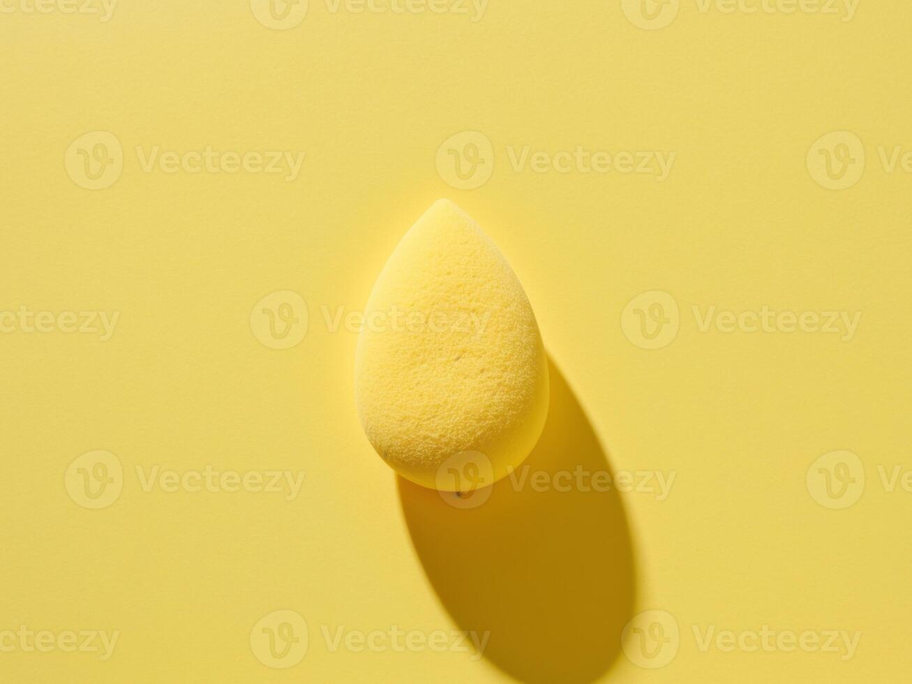 A yellow sponge on a yellow background photo
