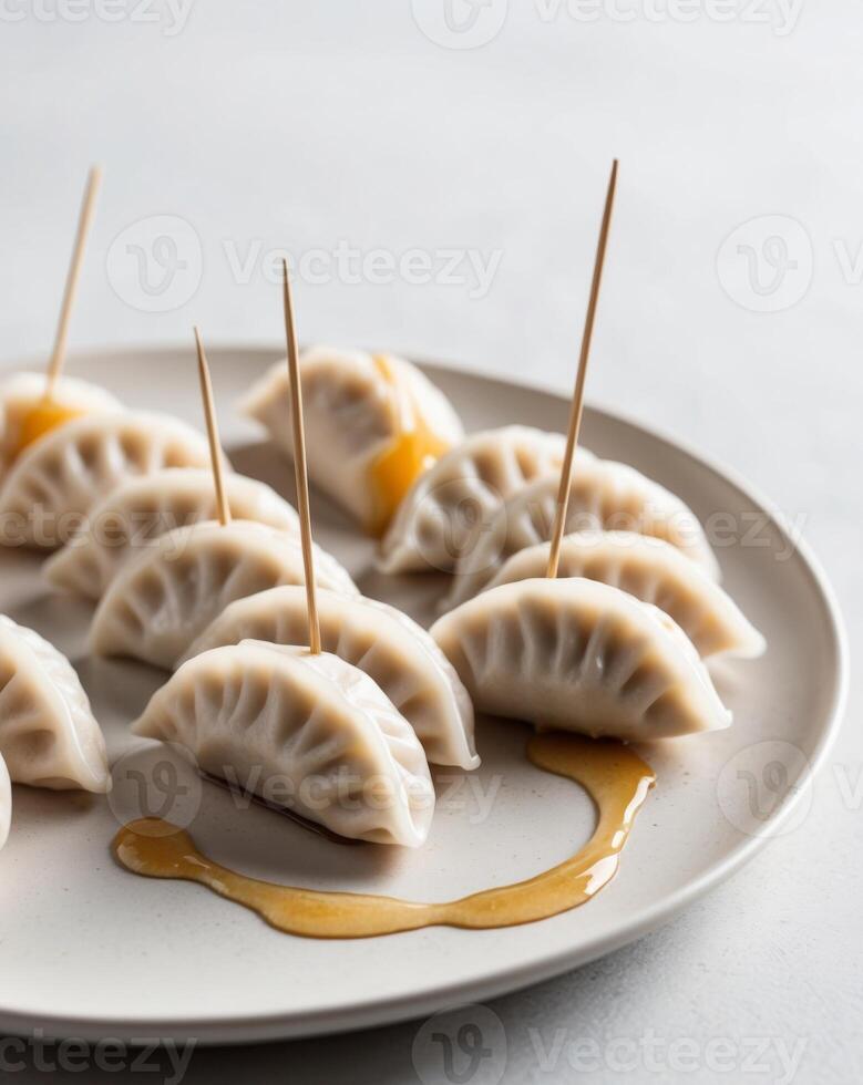 A plate with dumplings and toothpicks on it photo