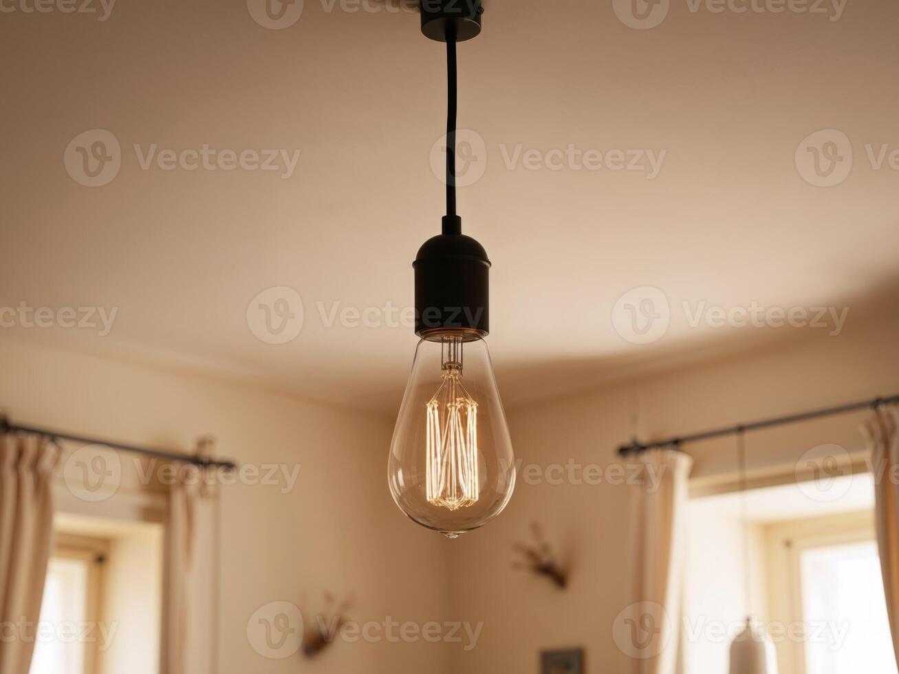 A light bulb hanging from a ceiling in a room photo