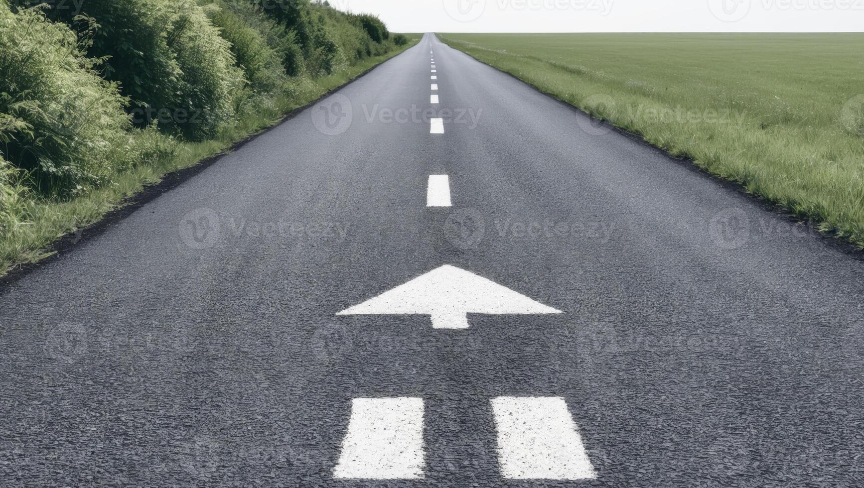 An empty road with two arrows pointing in opposite directions photo