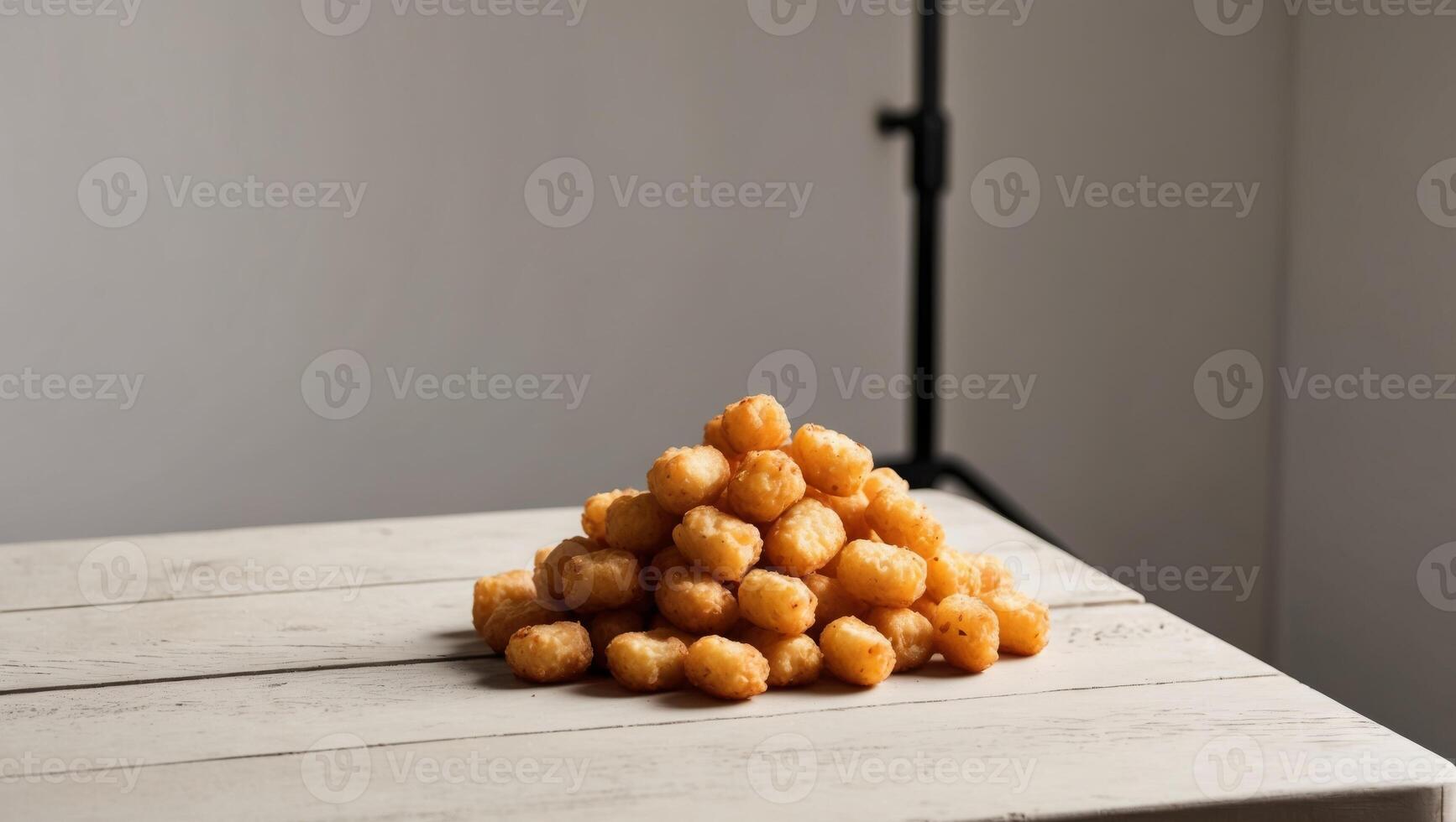 A pyramid of doughnuts sitting on top of a table photo
