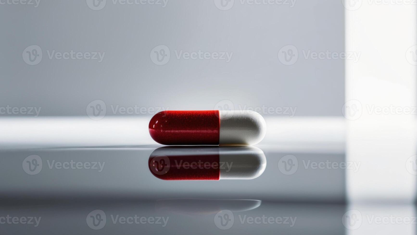 A red and white pill sitting on a table photo