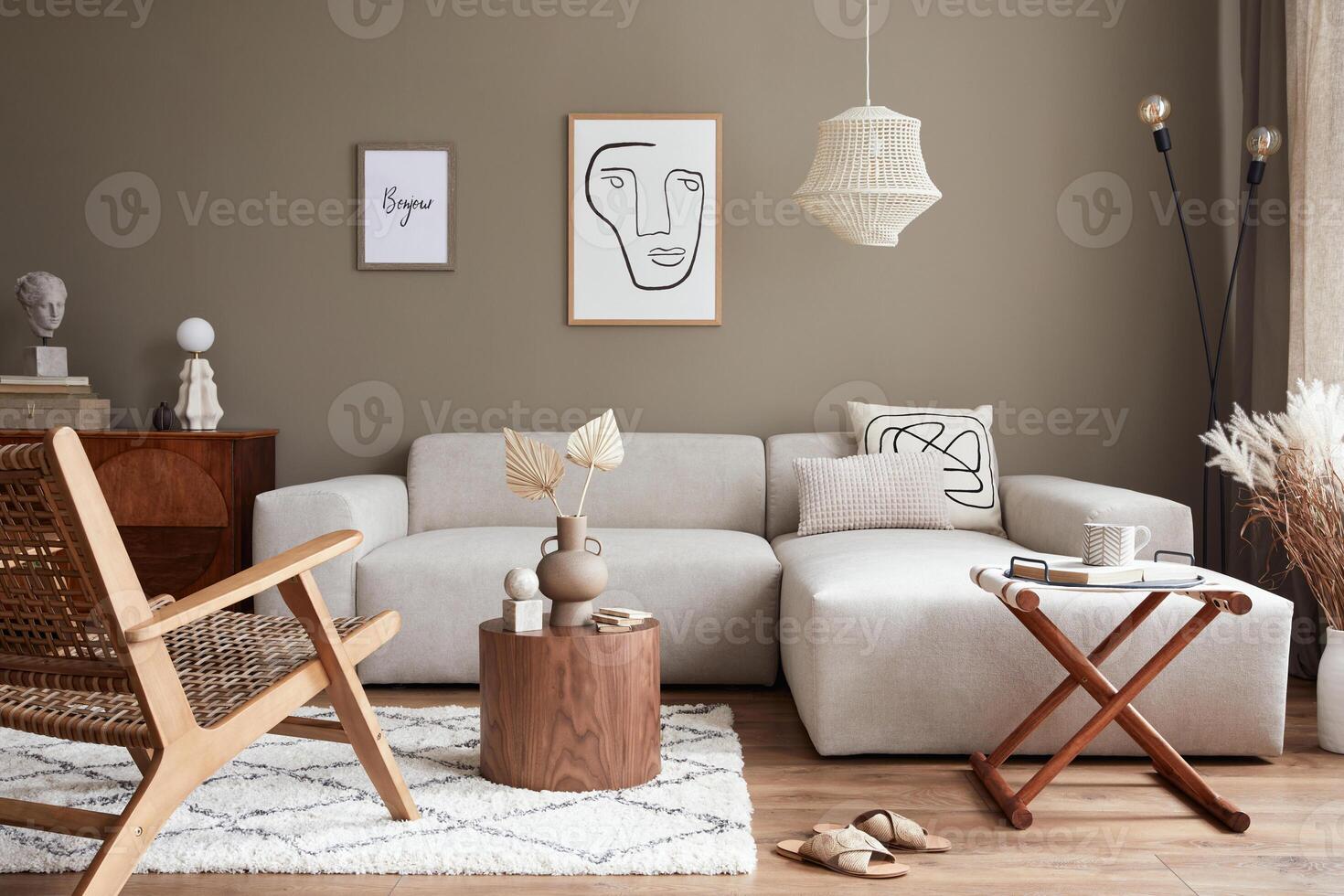 Stylish interior with design neutral modular sofa, mock up poster frames, armchair, coffee tables, dried flowers in vase, decoration and elegant personal accessories in modern home decor. photo