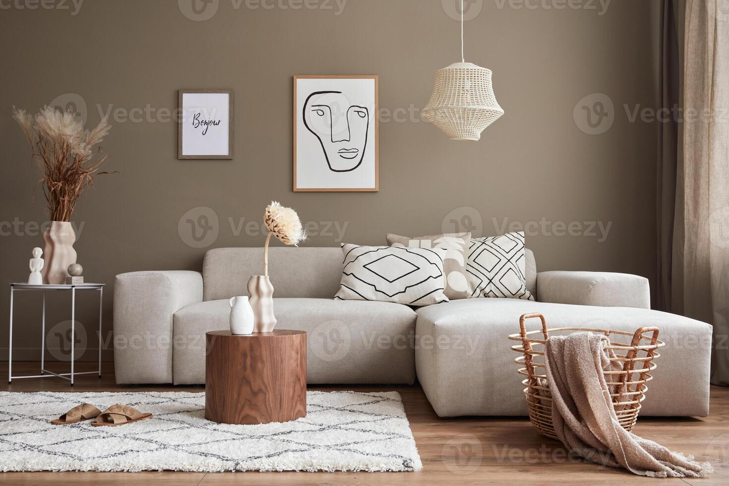 Interior design of stylish living room with modern sofa, mock up poster farmes, dried flowers in vase, coffee tables, decoration and elegant personal accessories in home decor. photo