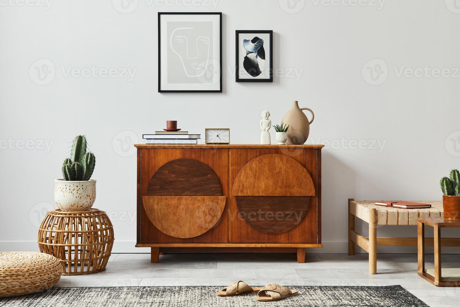 Stylish scandinavian composition of living room with design commode, black mock up poster frames, pouf, sofa, book, decoration and personal accessories in modern home decor. photo