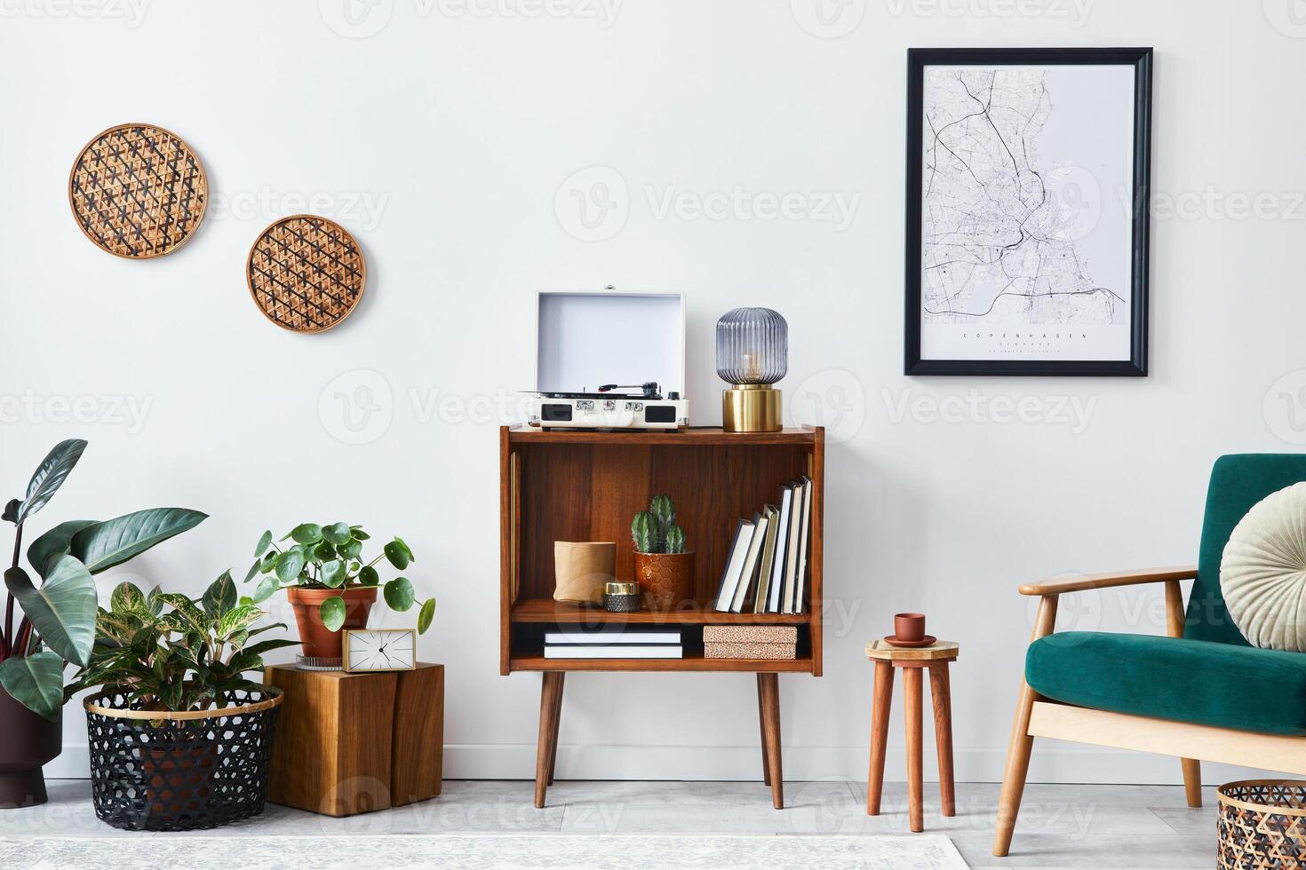 Stylish interior of living room with design wooden shelf, velvet sofa, a lot of plants, mock up poster map, vinyl recorder, book and personal accessories in vintage home decor. photo