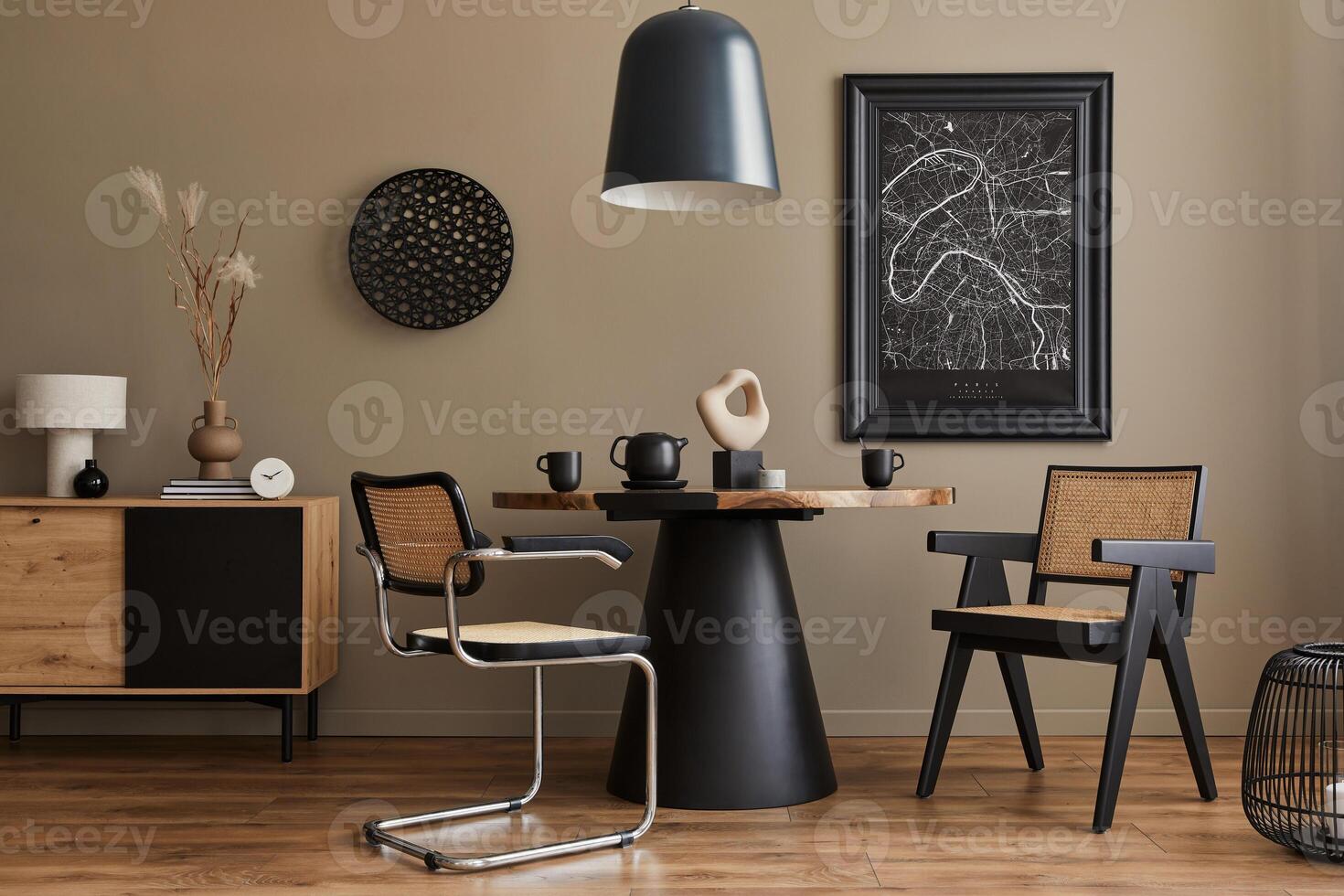 Modern composition of dining room interior with design wooden table, stylish chairs, teapot, cups, vessel, commode, black mock up poster map and elegant accessories in home decor. photo